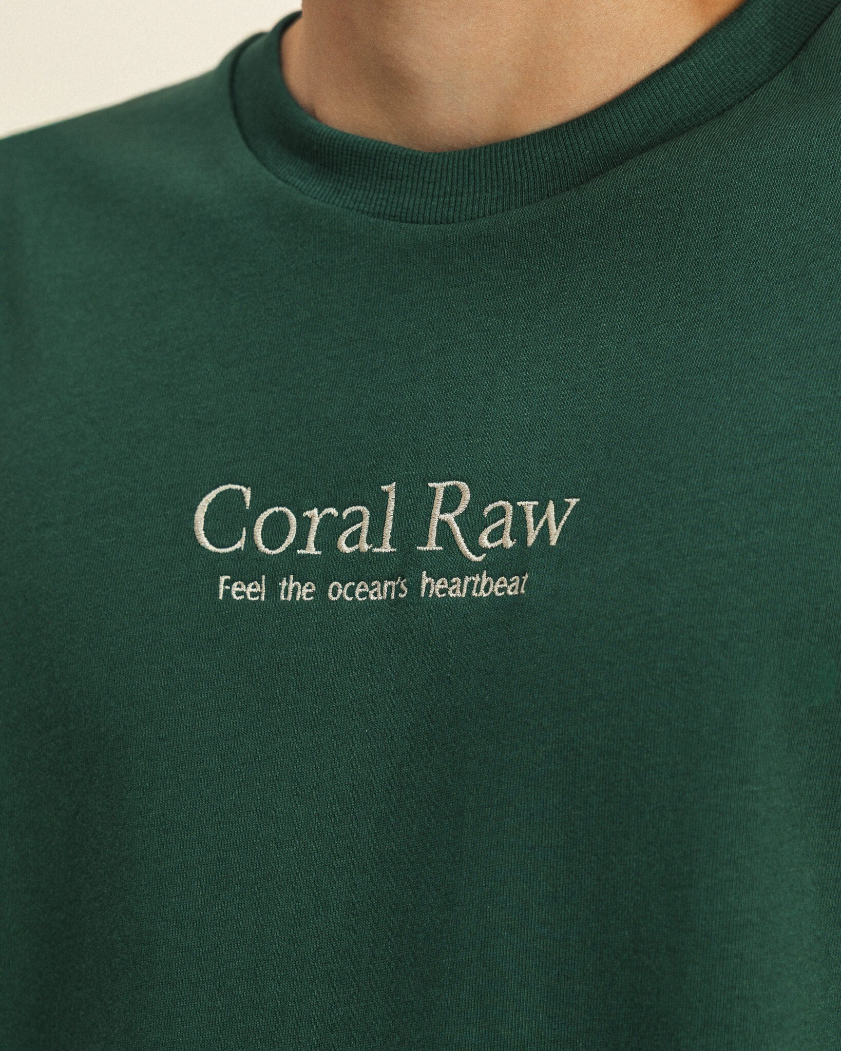 Close-up detail of the embroidery on the Feel the ocean's heartbeat T-shirt.