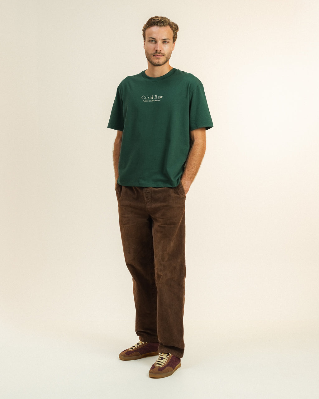 Man wearing the Feel the ocean's heartbeat T-shirt by Coral Raw, full body front view.