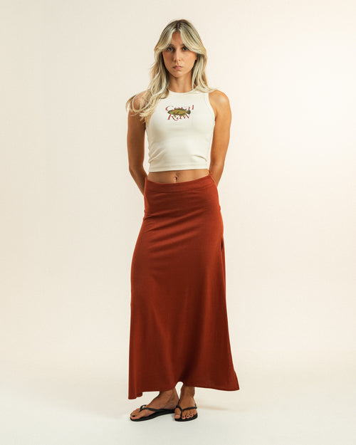 Woman wearing the low-rise Hibiscus Skirt by Coral Raw, full body front view.