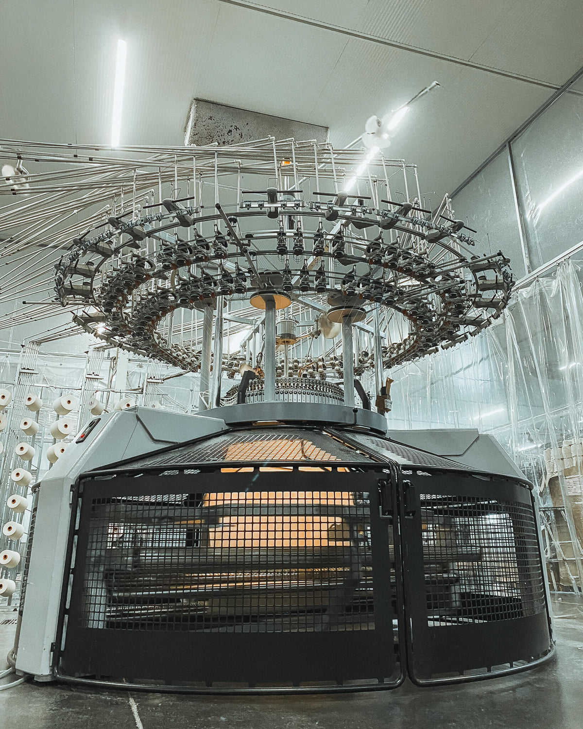 Close-up of a circular knitting machine in our partner textile workshop.