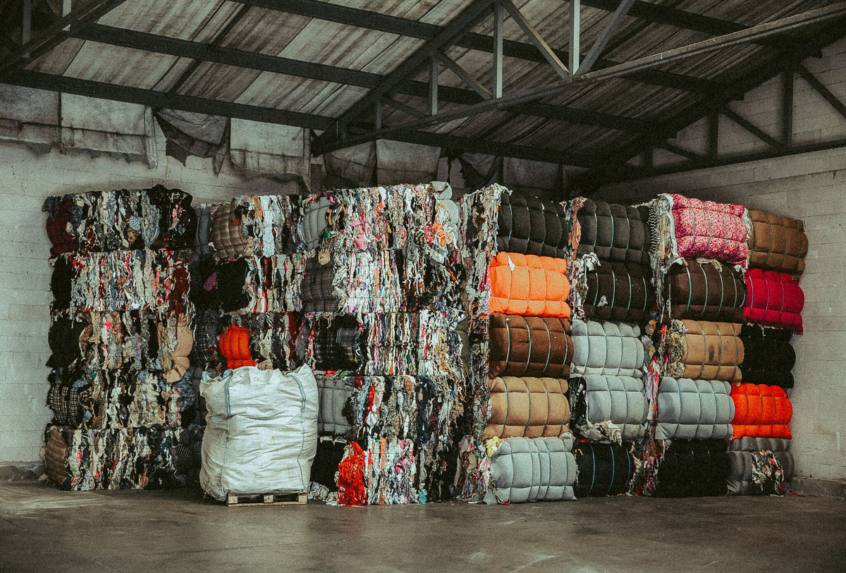 Compacted and tied bales of sorted post-consumer textile waste, serving as raw material for CIRCULOSE® production.